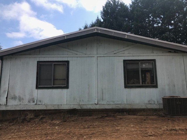 Before exterior renovation of Oregon home with worn siding and inefficient windows.