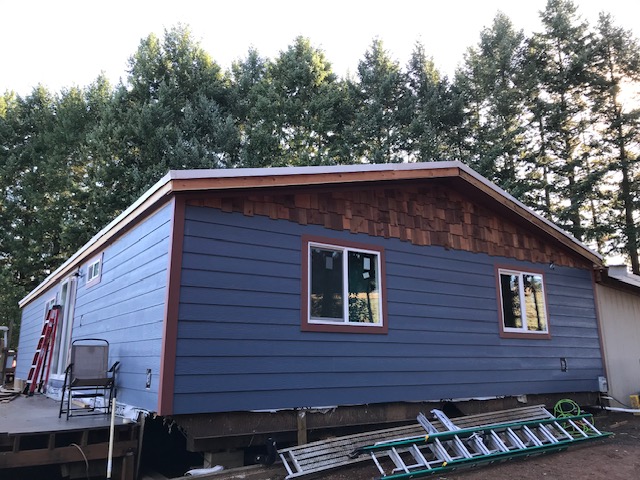 Oregon home after exterior renovation with cedar siding, new windows, new insulation, and completely weatherized .